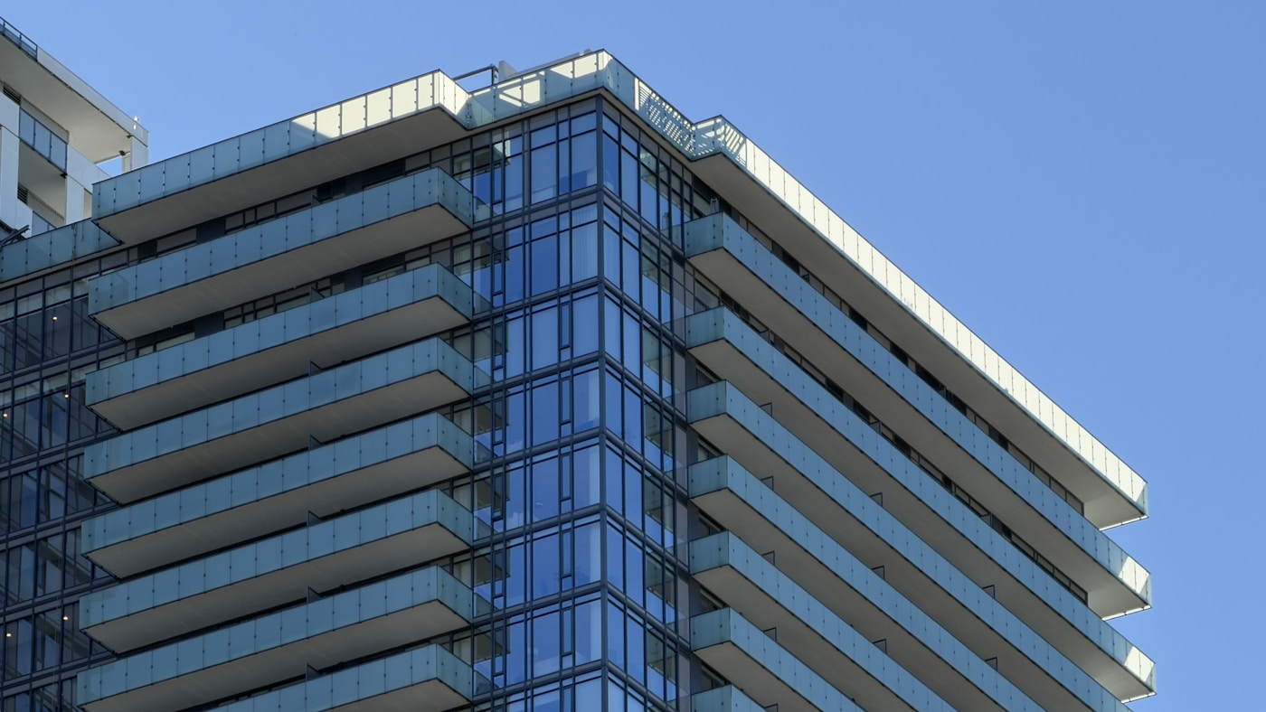 Modern white residential new-build with glass balconies